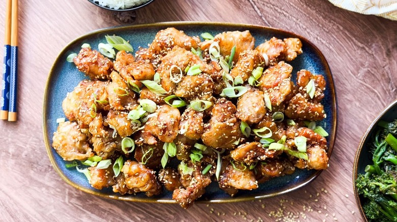 1-wok sesame chicken on serving platter with garnishes