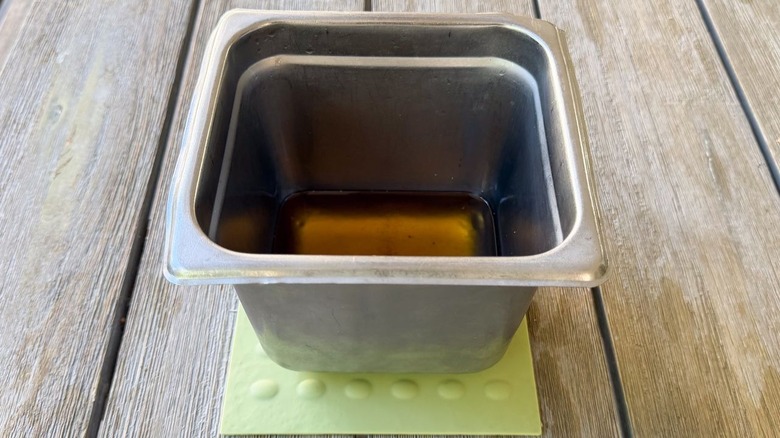 Stainless steel pan on trivet with hot peanut oil