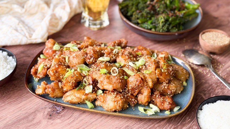 Side view of 1-wok sesame chicken on serving platter