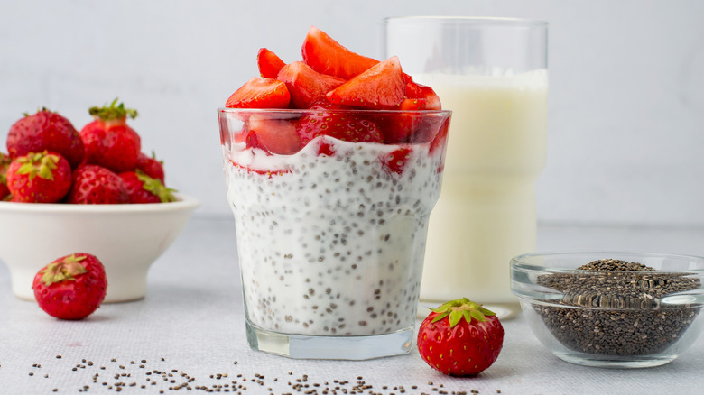 Chia pudding with fresh strawberries and a glass of milk
