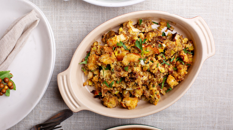 stuffing in a baking dish sitting on a white table cloth