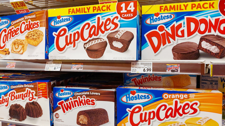 Selection of Hostess snack cakes in grocery store aisle.