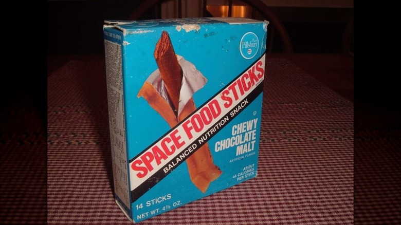 Space food sticks box on tablecloth in residential home.