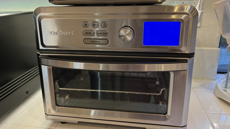 Fancy air-fryer sits on white tiled countertop