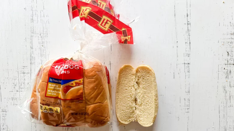 Hot dog bun on white surface