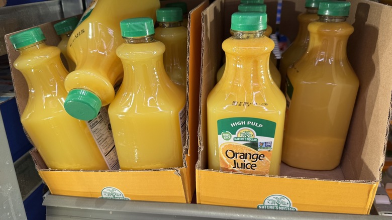 Orange juice inside of case at a grocery store