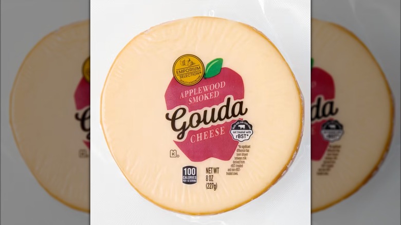 Applewood-smoked gouda cheese on white surface