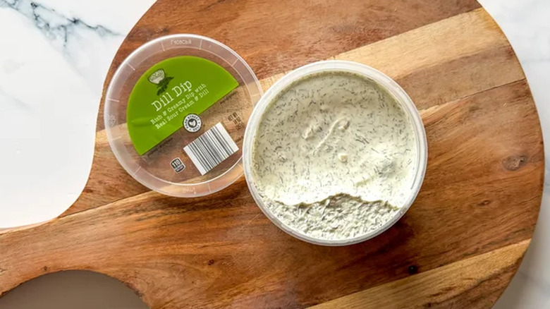 Aldi dill dip on a wooden surface
