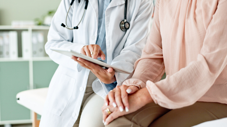 doctor and patient consulting in clinic room