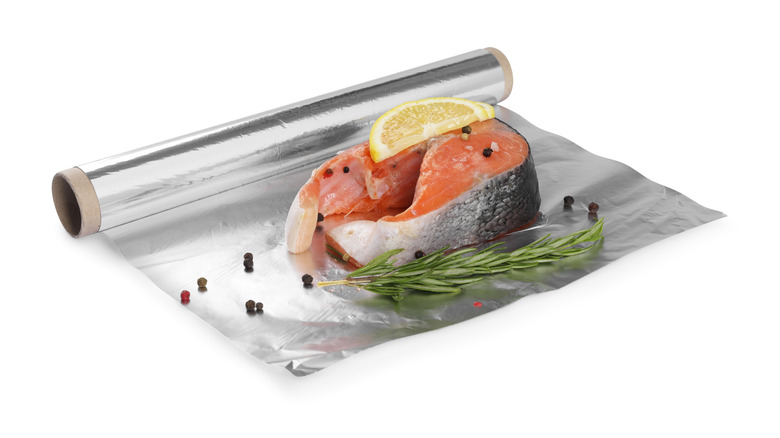 fish and other ingredients wrapped in aluminum foil
