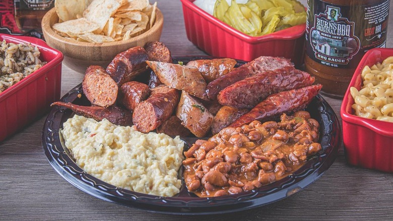 A plate of sausage with beans and potato salad at Burns Original Barbecue