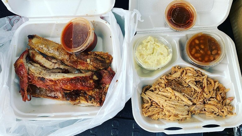 Two takeout containers of ribs and pulled pork from Scott's Bar-B-Que