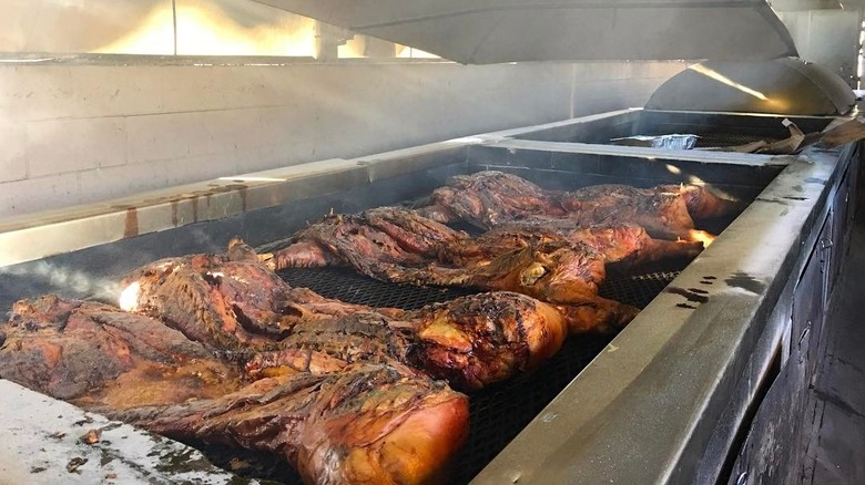Whole hogs cooking on the grill at Sweatman's Bar-B-Que