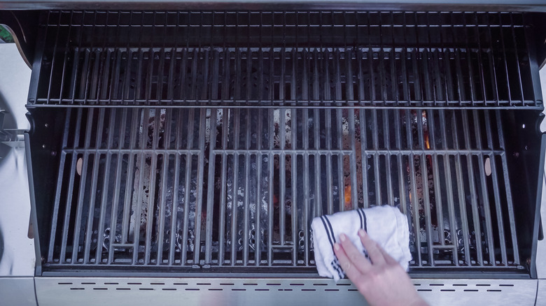 Person cleaning an outdoor grill