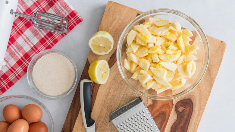 Apple pie ingredients with sliced lemons