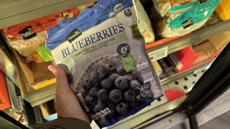 Frozen blueberries in hand