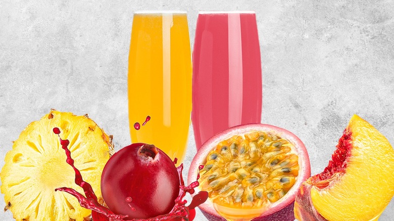 Tw0 flute glasses containing mimosa drinks, and fruits