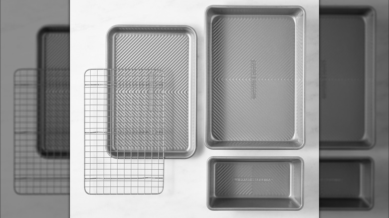 Three silver countertop ovenware and a cooling rack