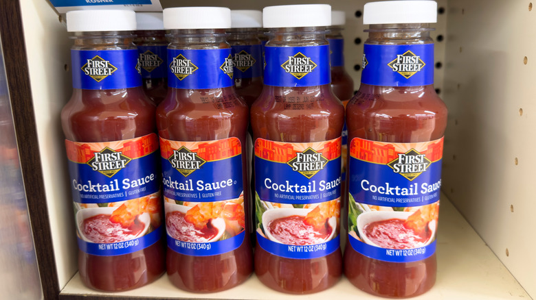 Glass bottles of cocktail sauce on grocery store shelf