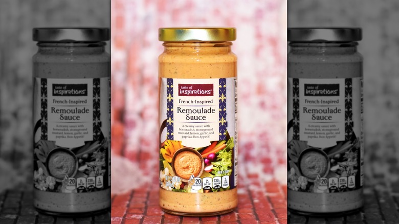 Jar of remoulade sauce placed on a red surface