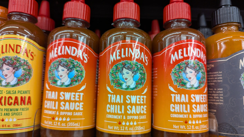 Bottles of sweet chili sauce on shelf