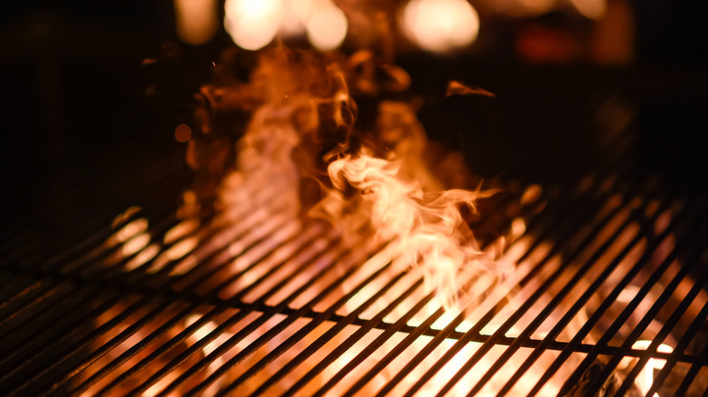 Flames underneath a barbecue grill