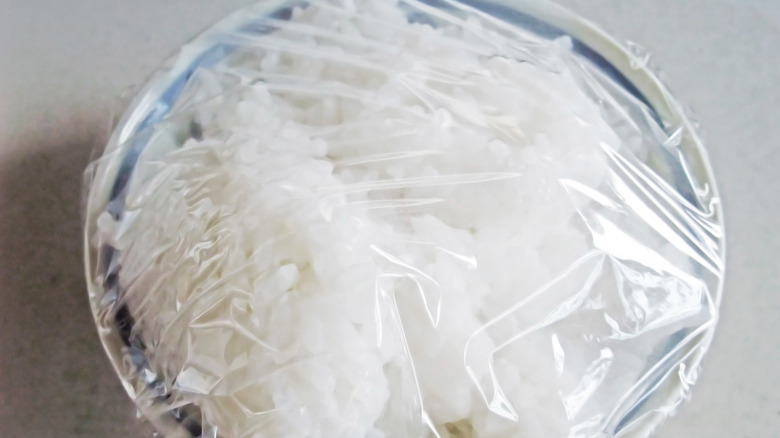 Leftover rice in a bowl with plastic wrap