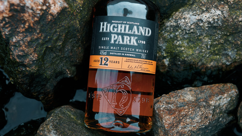 A bottle of Highland Park 12 year nestled amongst some river rocks