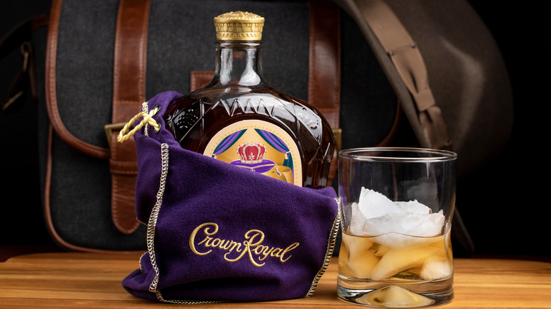 A bottle of Crown Royal peaking out if its purple and gold bag