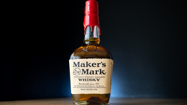 A bottle of red-waxed Maker's Mark on a black background