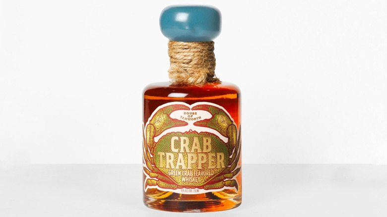 A bottle of Crab Trapper whiskey on a white background
