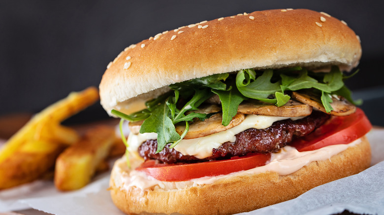Burger with greens and mushrooms on a plate