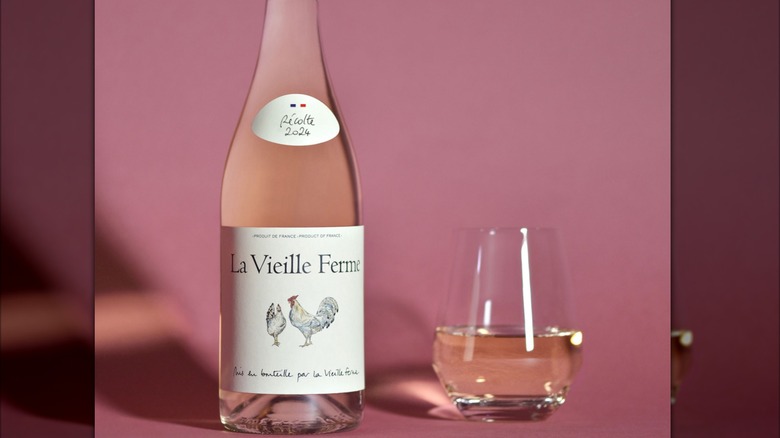 A bottle of La Vieille Ferme Rosé next to a glass of wine