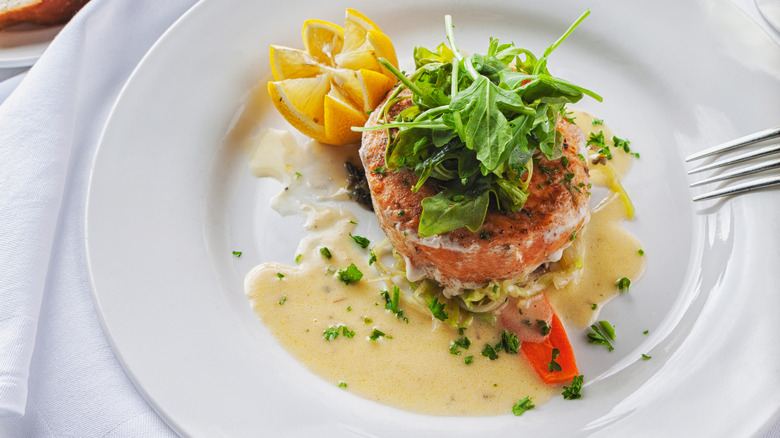 A plate of salmon tartar with a buerre blanc sauce