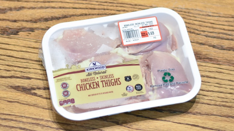 A container of Aldi raw chicken thighs