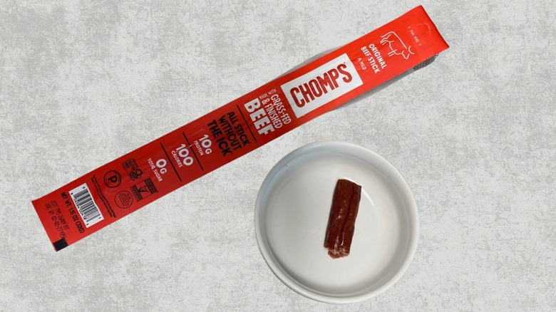 Chomps Original Beef stick next to a sample on a table