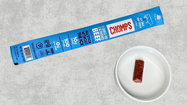 Chomps sea salt beef stick next to a sample on a table