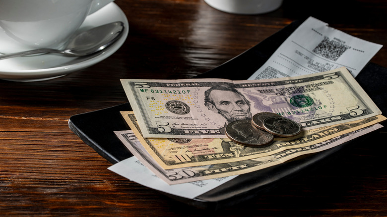 Money and coins on a bill