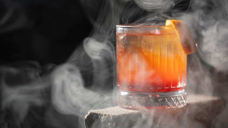 Smoked Negroni cocktail on a piece of stone
