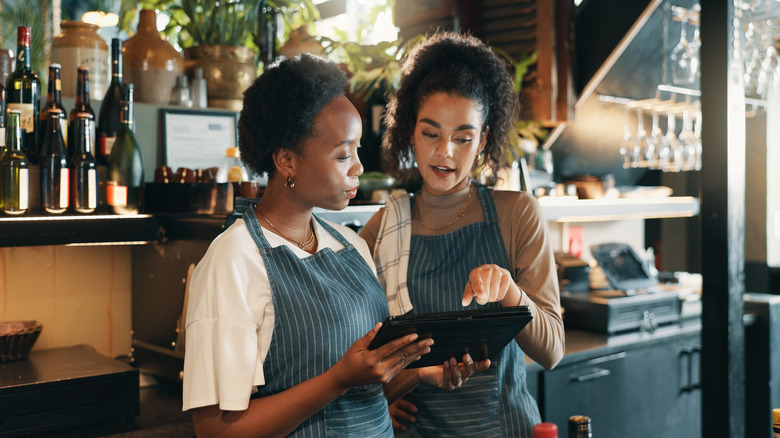 People looking at a tablet at a restaurant