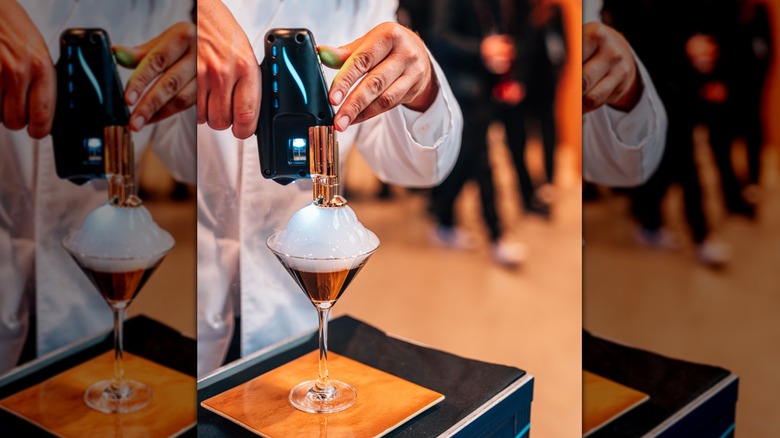 Bartender adding a bubble to a cocktail