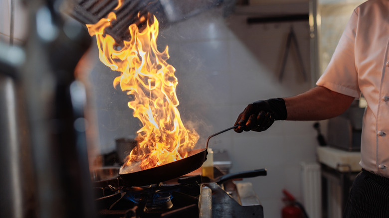 Restaurant kitchen with flaming pan