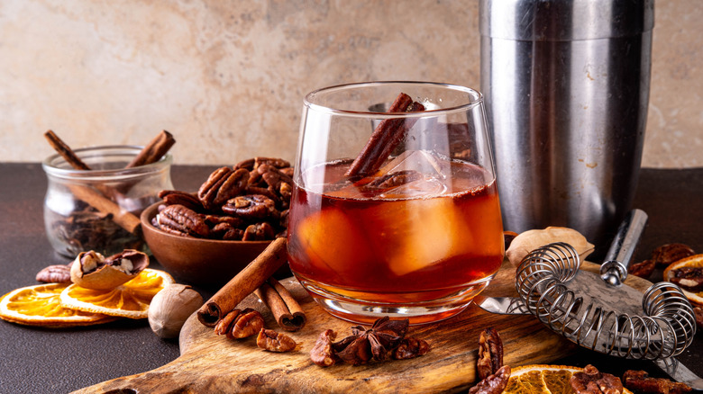 Bourbon cocktail with nuts and shaker