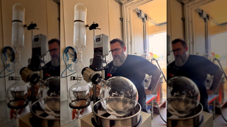 Person using a rotovap in a garage