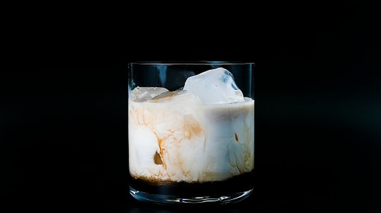 White Russian cocktail in a glass with a black background