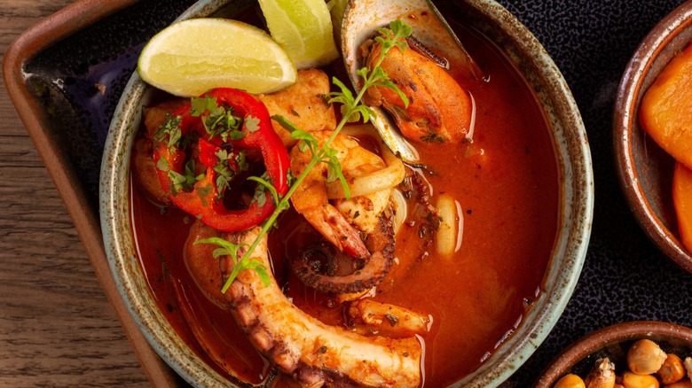 A bowl of colorful parihuela, a Peruvian seafood stew