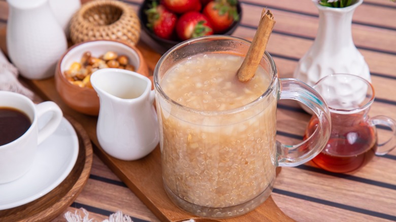A traditional Peruvian quinoa beverage with a cinnamon stick