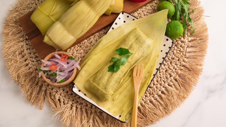 A Peruvian green tamal with a side of salsa criolla