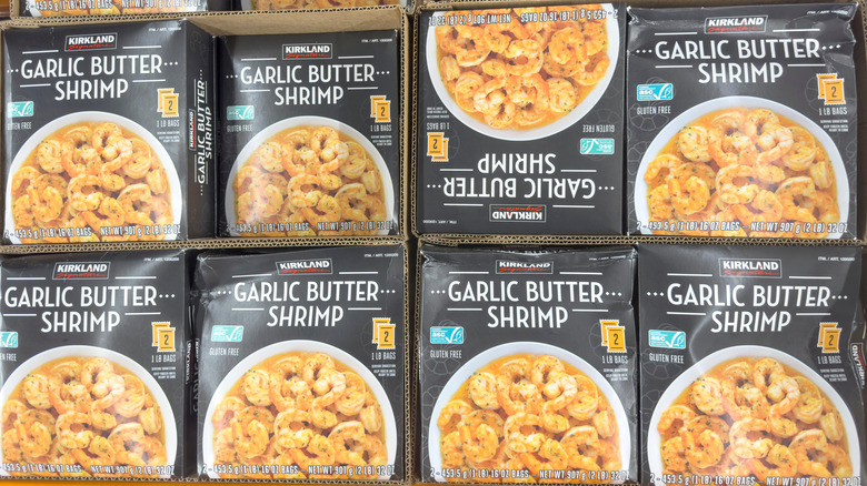 Boxes of Kirkland Signature Garlic Butter Shrimp at a Costco warehouse