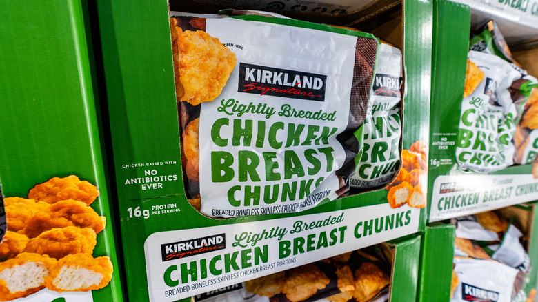 Bags of Kirkland Signature Lightly Breaded Chicken Breast Chunks at a Costco warehouse